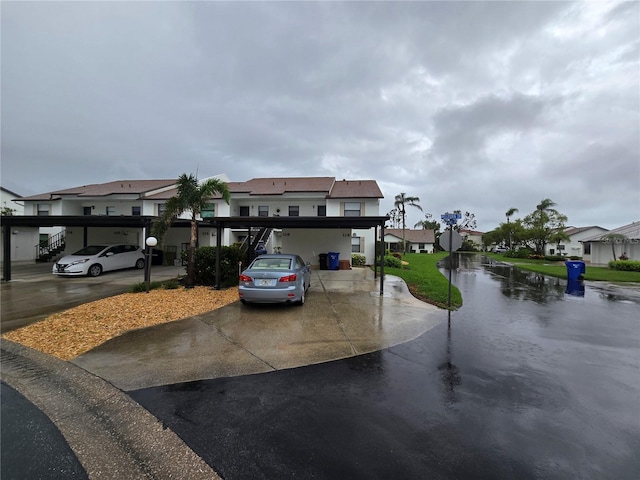 1211 Capri Isles Blvd Unit 116, Venice, FL 34292 - multi unit property with a residential view, a carport, and stucco siding