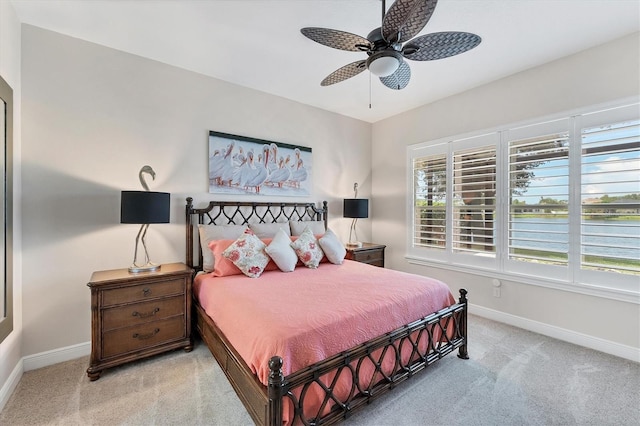 5142 51st Ln W, Bradenton, FL 34210 - bedroom with light colored carpet, multiple windows, and ceiling fan