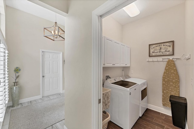 5142 51st Ln W, Bradenton, FL 34210 - laundry area with cabinet space, washing machine and clothes dryer, a chandelier, and dark wood-style flooring