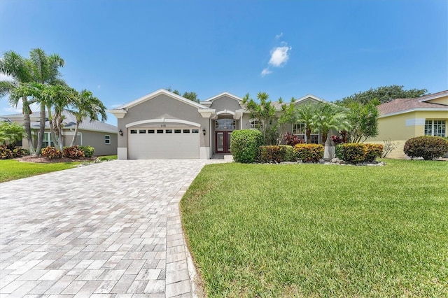 5142 51st Ln W, Bradenton, FL 34210 - ranch-style house with a garage, decorative driveway, a front yard, and stucco siding