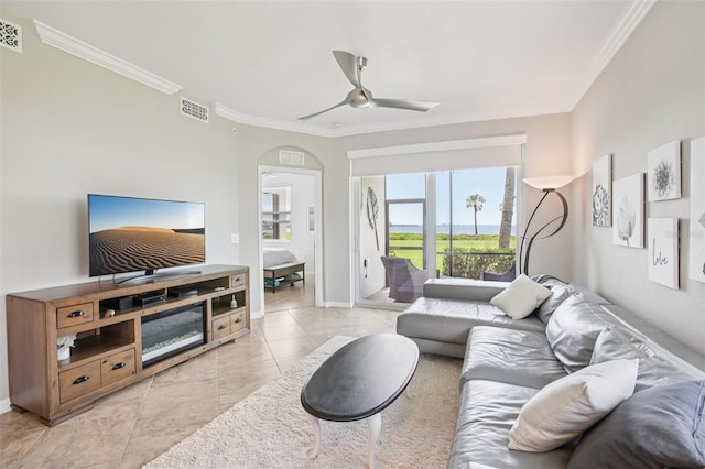 850 Tidewater Shores Loop Unit 108, Bradenton, FL 34208 - living area with crown molding, ceiling fan, baseboards, light tile patterned floors, and arched walkways