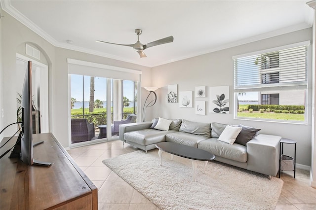 850 Tidewater Shores Loop Unit 108, Bradenton, FL 34208 - living room with light tile patterned floors, plenty of natural light, crown molding, ceiling fan, and baseboards