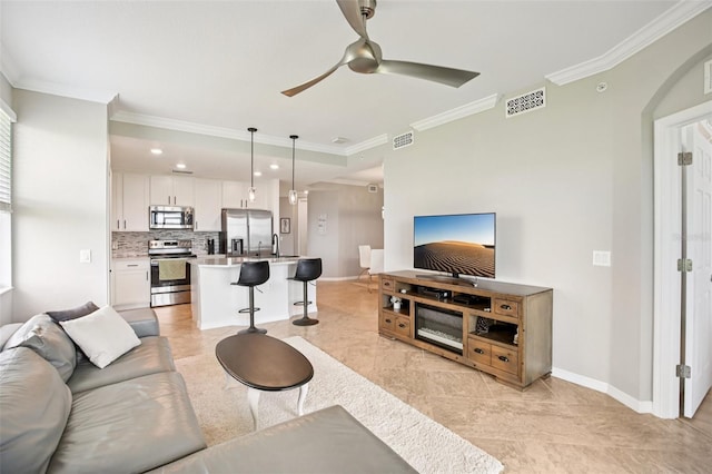850 Tidewater Shores Loop Unit 108, Bradenton, FL 34208 - living room with ornamental molding, a ceiling fan, baseboards, arched walkways, and recessed lighting