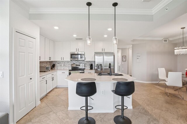850 Tidewater Shores Loop Unit 108, Bradenton, FL 34208 - kitchen with stainless steel appliances, tasteful backsplash, a sink, crown molding, and white cabinets