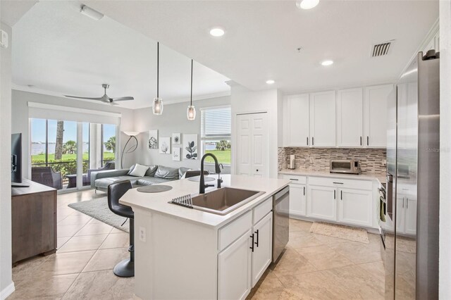 850 Tidewater Shores Loop Unit 108, Bradenton, FL 34208 - kitchen with a sink, appliances with stainless steel finishes, open floor plan, backsplash, and light countertops