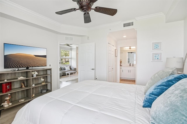 850 Tidewater Shores Loop Unit 108, Bradenton, FL 34208 - bedroom with ornamental molding, ensuite bath, ceiling fan, wood finished floors, and a sink