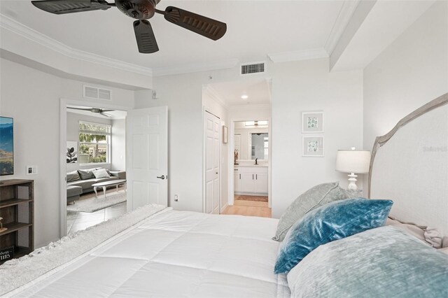 850 Tidewater Shores Loop Unit 108, Bradenton, FL 34208 - bedroom featuring crown molding, ensuite bath, a sink, and ceiling fan