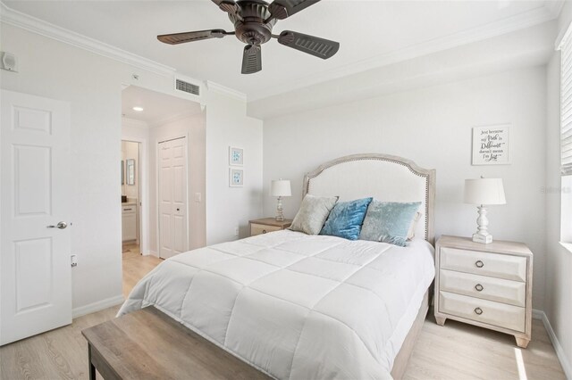850 Tidewater Shores Loop Unit 108, Bradenton, FL 34208 - bedroom featuring light wood-type flooring, crown molding, baseboards, ensuite bath, and ceiling fan
