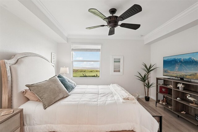 850 Tidewater Shores Loop Unit 108, Bradenton, FL 34208 - bedroom featuring wood finished floors, crown molding, baseboards, and a ceiling fan