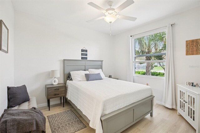 850 Tidewater Shores Loop Unit 108, Bradenton, FL 34208 - bedroom with light wood finished floors, baseboards, and ceiling fan