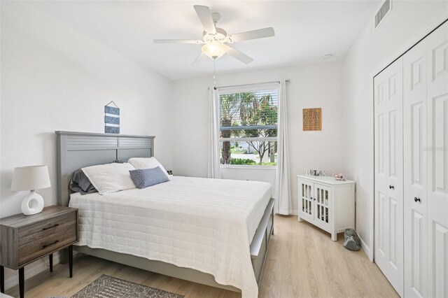 850 Tidewater Shores Loop Unit 108, Bradenton, FL 34208 - bedroom with light wood-type flooring, a closet, and a ceiling fan