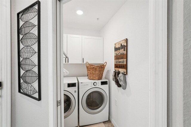 850 Tidewater Shores Loop Unit 108, Bradenton, FL 34208 - washroom featuring washing machine and dryer and cabinet space