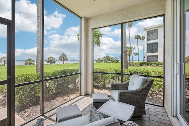 850 Tidewater Shores Loop Unit 108, Bradenton, FL 34208 - sunroom featuring a water view and healthy amount of natural light