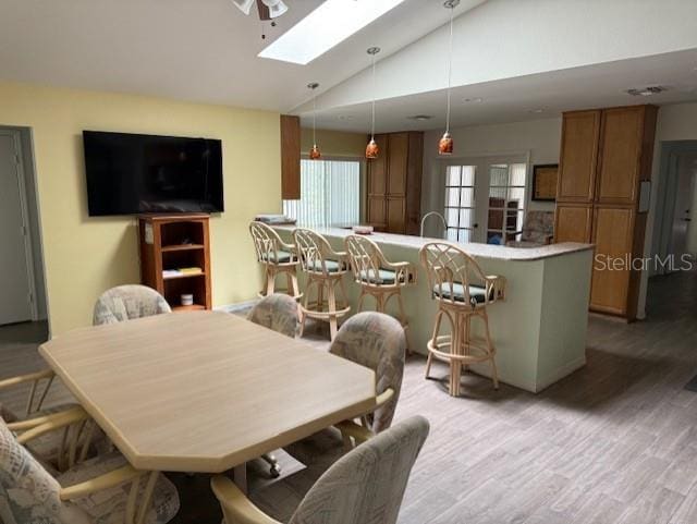20170 Tralee Dr, Port Charlotte, FL 33952 - dining room with a skylight, lofted ceiling, and light wood-style flooring