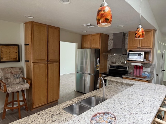 20170 Tralee Dr, Port Charlotte, FL 33952 - kitchen featuring wall chimney exhaust hood, appliances with stainless steel finishes, wood finished floors, light stone countertops, and recessed lighting