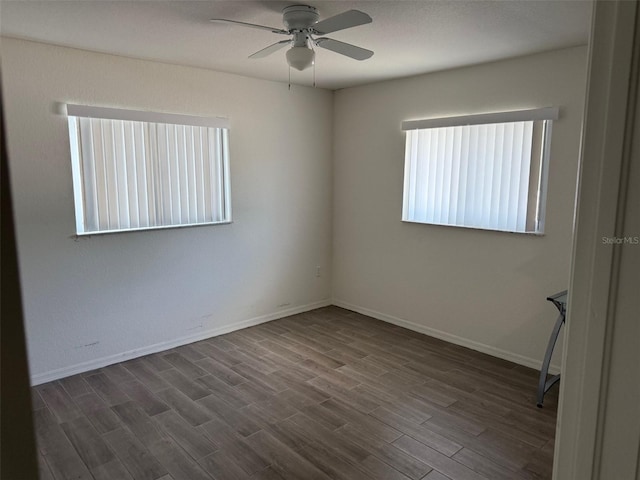 20170 Tralee Dr, Port Charlotte, FL 33952 - empty room with a ceiling fan, dark wood-style flooring, and baseboards