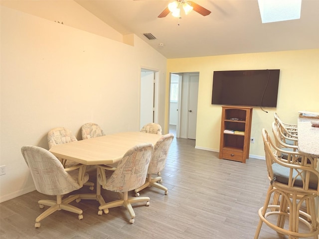 20170 Tralee Dr, Port Charlotte, FL 33952 - dining room featuring vaulted ceiling, a ceiling fan, a skylight, and light wood-type flooring