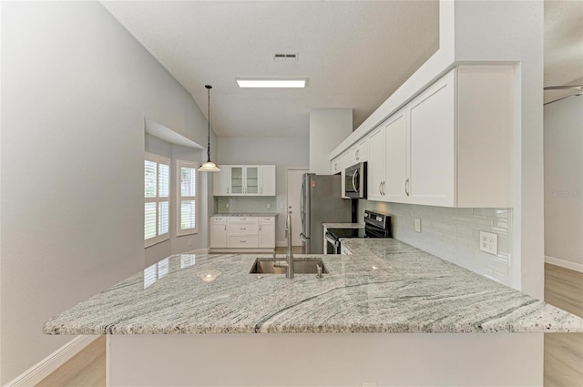 4811 14th Ave E, Bradenton, FL 34208 - kitchen featuring stainless steel appliances, a peninsula, light stone counters, and backsplash