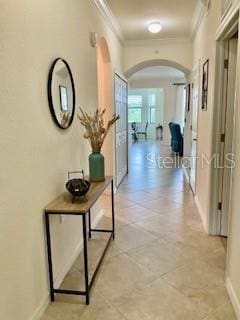 16804 Vardon Ter Unit 307, Bradenton, FL 34211 - hall featuring arched walkways, crown molding, and baseboards