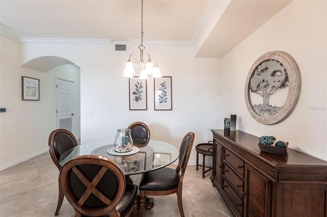 16804 Vardon Ter Unit 307, Bradenton, FL 34211 - dining space with crown molding, a chandelier, arched walkways, baseboards, and light tile patterned flooring