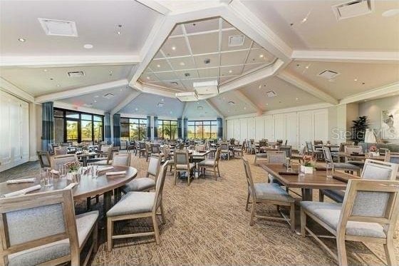 16804 Vardon Ter Unit 307, Bradenton, FL 34211 - carpeted dining room featuring vaulted ceiling
