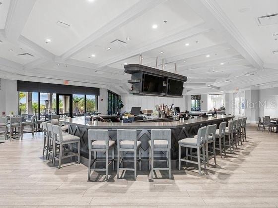 16804 Vardon Ter Unit 307, Bradenton, FL 34211 - bar with light wood-style floors, coffered ceiling, beam ceiling, and recessed lighting