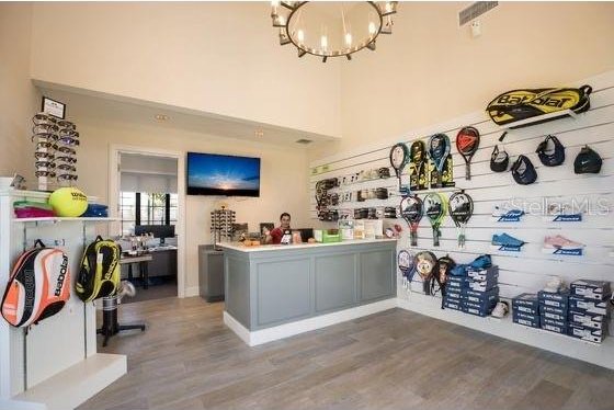16804 Vardon Ter Unit 307, Bradenton, FL 34211 - bar featuring a chandelier and wood finished floors