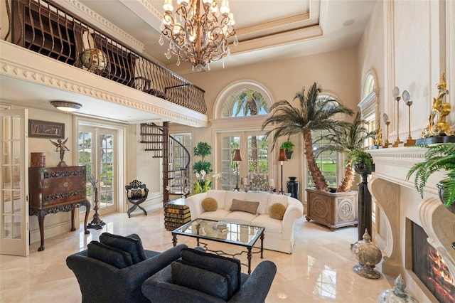 845 Longboat Club Rd, Longboat Key, FL 34228 - living room featuring french doors, a fireplace, a towering ceiling, a chandelier, and a tray ceiling