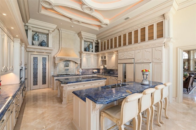 845 Longboat Club Rd, Longboat Key, FL 34228 - kitchen with a large island, crown molding, a sink, stainless steel appliances, and light marble finish floors