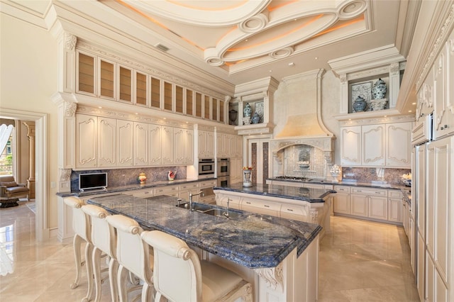 845 Longboat Club Rd, Longboat Key, FL 34228 - kitchen featuring a sink, a towering ceiling, a large island with sink, ornamental molding, and a breakfast bar