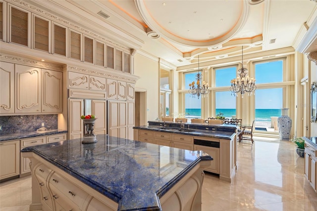 845 Longboat Club Rd, Longboat Key, FL 34228 - kitchen with a chandelier, a center island, cream cabinets, a high ceiling, and ornamental molding