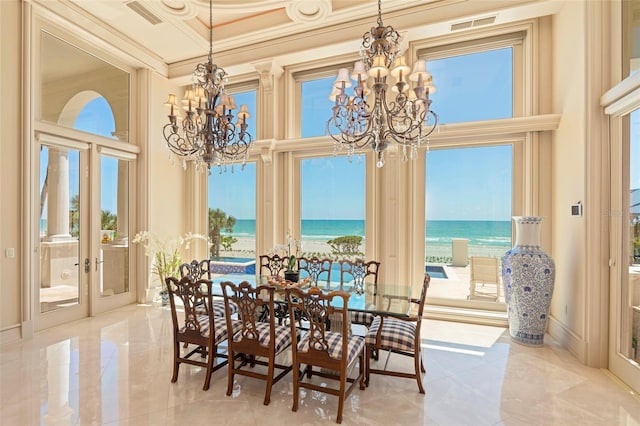 845 Longboat Club Rd, Longboat Key, FL 34228 - dining room featuring a chandelier, a towering ceiling, a water view, crown molding, and french doors