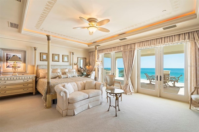 845 Longboat Club Rd, Longboat Key, FL 34228 - carpeted bedroom with a tray ceiling, access to outside, a water view, french doors, and crown molding