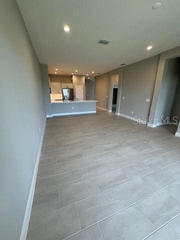 24827 Buckingham Way, Port Charlotte, FL 33980 - unfurnished living room with baseboards, recessed lighting, and light tile patterned flooring