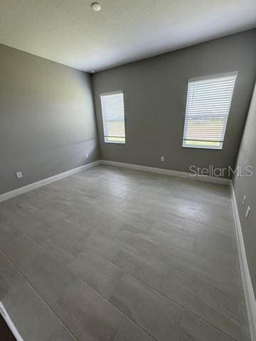 24827 Buckingham Way, Port Charlotte, FL 33980 - empty room featuring baseboards