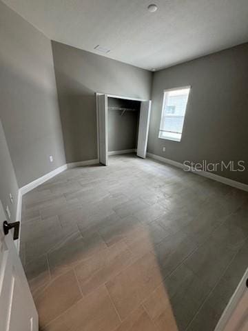 24827 Buckingham Way, Port Charlotte, FL 33980 - unfurnished bedroom with baseboards and a closet