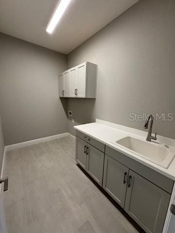 24827 Buckingham Way, Port Charlotte, FL 33980 - laundry area with cabinet space, baseboards, and electric dryer hookup