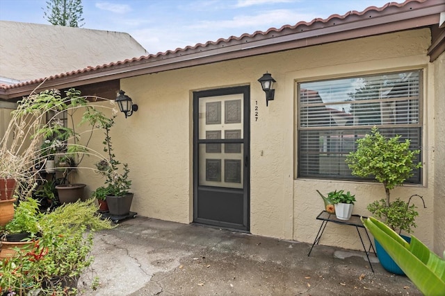 1227 56th St W Unit 1227, Bradenton, FL 34209 - doorway to property with stucco siding and a patio