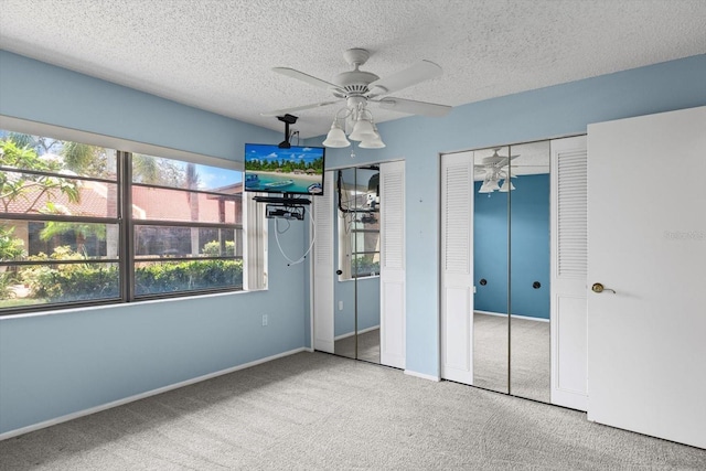 1227 56th St W Unit 1227, Bradenton, FL 34209 - unfurnished bedroom with two closets, carpet, and a textured ceiling