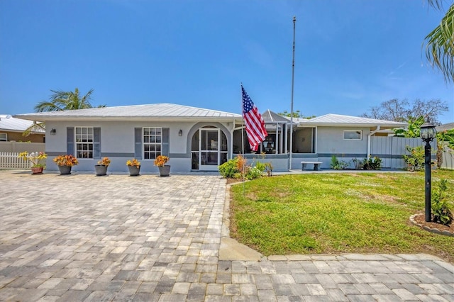 619 Albee Farm Rd N, Nokomis, FL 34275 - view of front of house with stucco siding, metal roof, a lanai, and a standing seam roof
