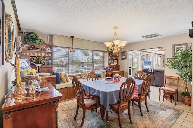 619 Albee Farm Rd N, Nokomis, FL 34275 - dining area with a chandelier, light tile patterned flooring, and a textured ceiling