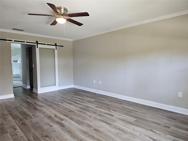 5207 86th Street Ct W, Bradenton, FL 34210 - unfurnished room with a barn door, baseboards, a ceiling fan, wood finished floors, and crown molding