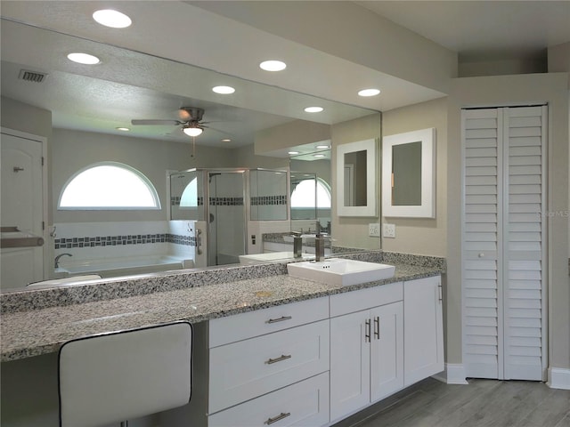 5207 86th Street Ct W, Bradenton, FL 34210 - bathroom with a closet, a stall shower, ceiling fan, vanity, and a bath