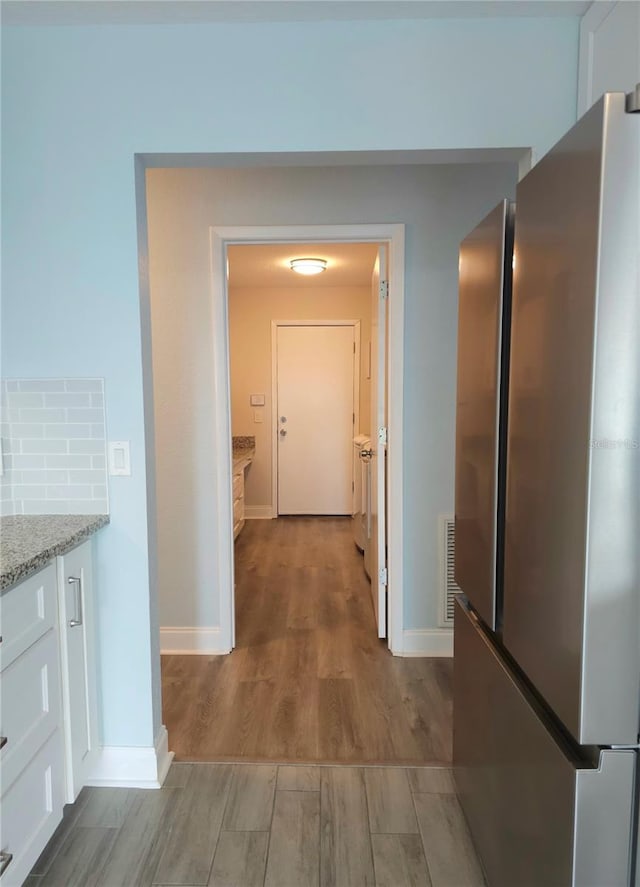 5207 86th Street Ct W, Bradenton, FL 34210 - hallway with wood finished floors and baseboards