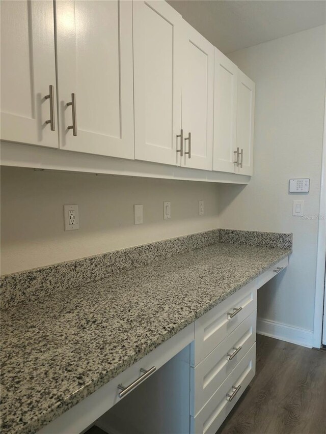 5207 86th Street Ct W, Bradenton, FL 34210 - kitchen with white cabinetry, baseboards, light stone countertops, and dark wood finished floors