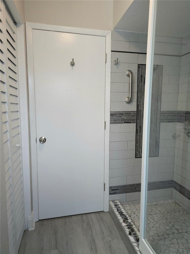5207 86th Street Ct W, Bradenton, FL 34210 - bathroom with a stall shower and wood finished floors