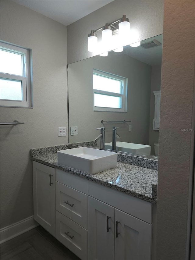 5207 86th Street Ct W, Bradenton, FL 34210 - bathroom featuring vanity, baseboards, and a textured wall