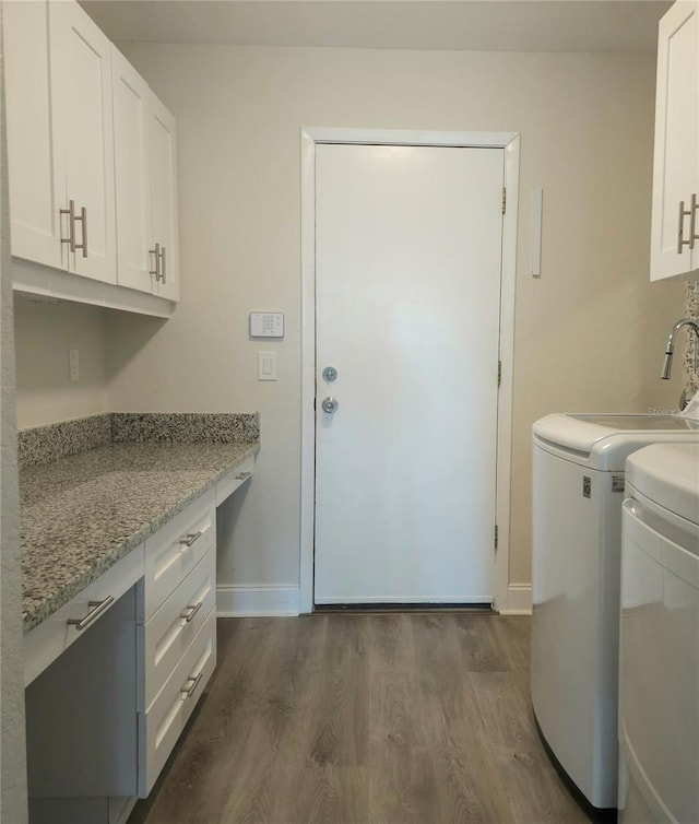 5207 86th Street Ct W, Bradenton, FL 34210 - washroom featuring dark wood-style floors, cabinet space, baseboards, and separate washer and dryer