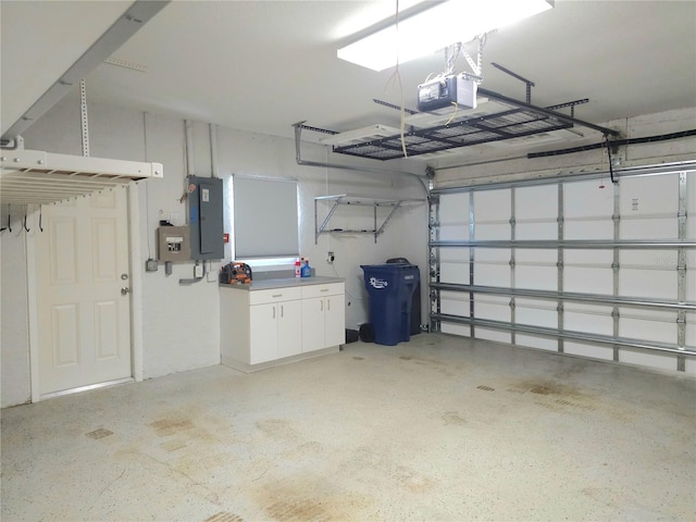 5207 86th Street Ct W, Bradenton, FL 34210 - garage featuring electric panel and a garage door opener