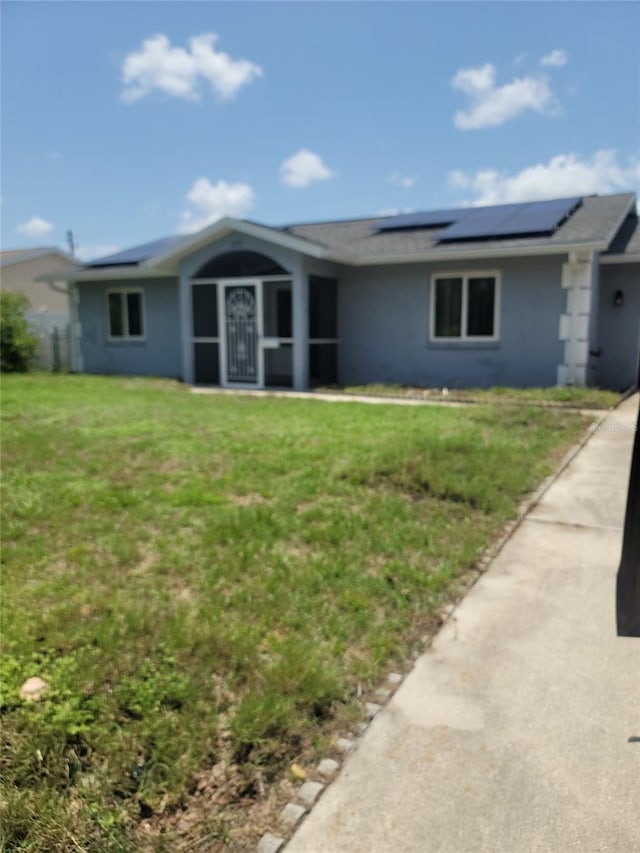 3339 Duar Ter, North Port, FL 34291 - ranch-style house with roof mounted solar panels, a front yard, and stucco siding